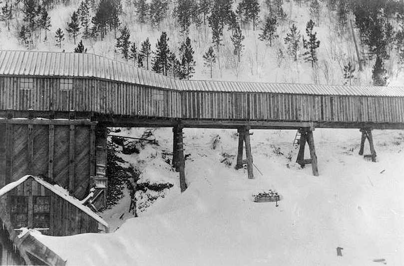 Bald Mountain Gold Mill, Lead South Dakota EAGLE MILL, DETAIL OF CRUDE ORE BIN FROM NORTH, c. 1908-10. SHOWS EXPOSED CRUSHER HOUSE IN FRONT OF (SOUTH) CRUDE ORE BIN AND SNOW SHED ADDED OVER TRAM TRACKS. NOTE LACK OF EAST OR WEST CRUDE ORE BINS