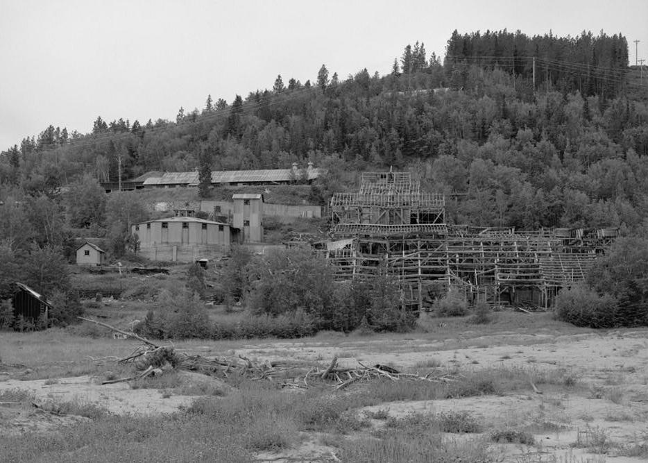 Bald Mountain Gold Mill, Lead South Dakota 1992 VIEW OF MILL FROM UPPER TAILINGS POND (NORTH). ROASTER ON LEFT WITH ELEVATOR/CRUSHED ORE BIN TOWER TO RIGHT. MAIN MILL BUILDING IN CENTER WITH THICKENER ADDITION TO RIGHT. MACHINE SHOP ON CRUDE ORE BIN TERRACE ABOVE ROASTER. THE LOCATION OF THE 100,000 GALLON MILL WATER TANK CAN BE SEEN AT THE CENTER RIGHT NEAR THE TOP OF THE MOUNTAIN.