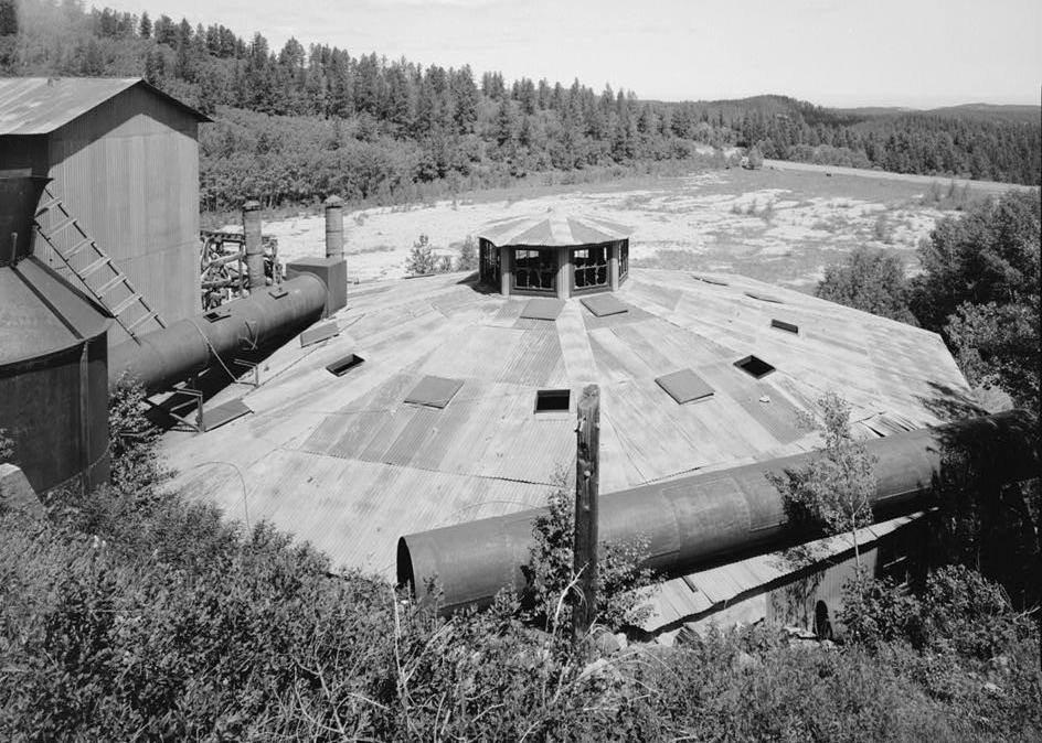 Bald Mountain Gold Mill, Lead South Dakota 1992 VIEW OF ROASTER  ADDITION FROM SOUTHEAST. SHOWS ELEVATOR/ORE BIN ADDITION ON LEFT WITH BASE OF EXHAUST STACK, PORTION OF TOPPLED STACK ON LOWER RIGHT IN VIEW, AND UPPER TAILINGS POND BEYOND.