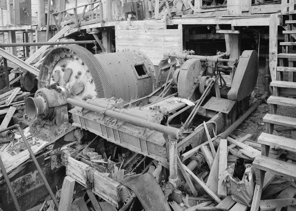 Bald Mountain Gold Mill, Lead South Dakota 1992 PRIMARY MILL AND CLASSIFIER No. 2 FROM NORTHWEST. MILL DISCHARGED INTO LAUNDER WHICH PIERCED THE SIDE OF THE CLASSIFIER PAN. WOOD LAUNDER WITHIN CLASSIFIER VISIBLE (FILLED WITH DEBRIS). HORIZONTAL WOOD PLANKING BEHIND MILL IS FEED BOX. MILL SOLUTION PIPING RUNS ALONG BASE OF WEST SIDE OF CLASSIFIER.