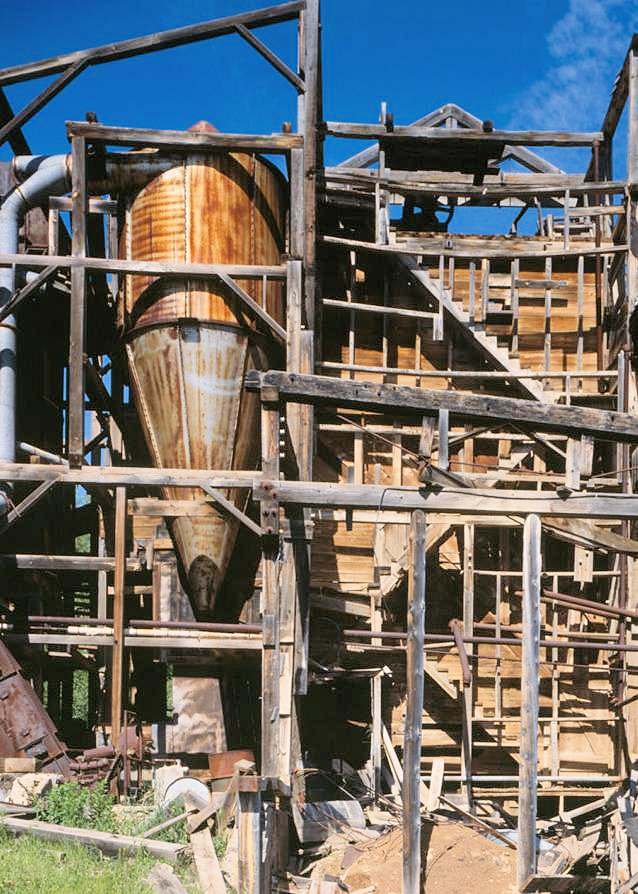 Bald Mountain Gold Mill, Lead South Dakota 1992 VIEW OF DUST COLLECTOR AND CRUSHED OXIDIZED ORE BIN FROM EAST. THE DUCTWORK TO TOP OF COLLECTOR (OPEN END, MIDDLE LEFT) CONNECTED TO HOODS OVER SYMONS SCREEN, ROD MILL, AND BAKER COOLER DISCHARGE