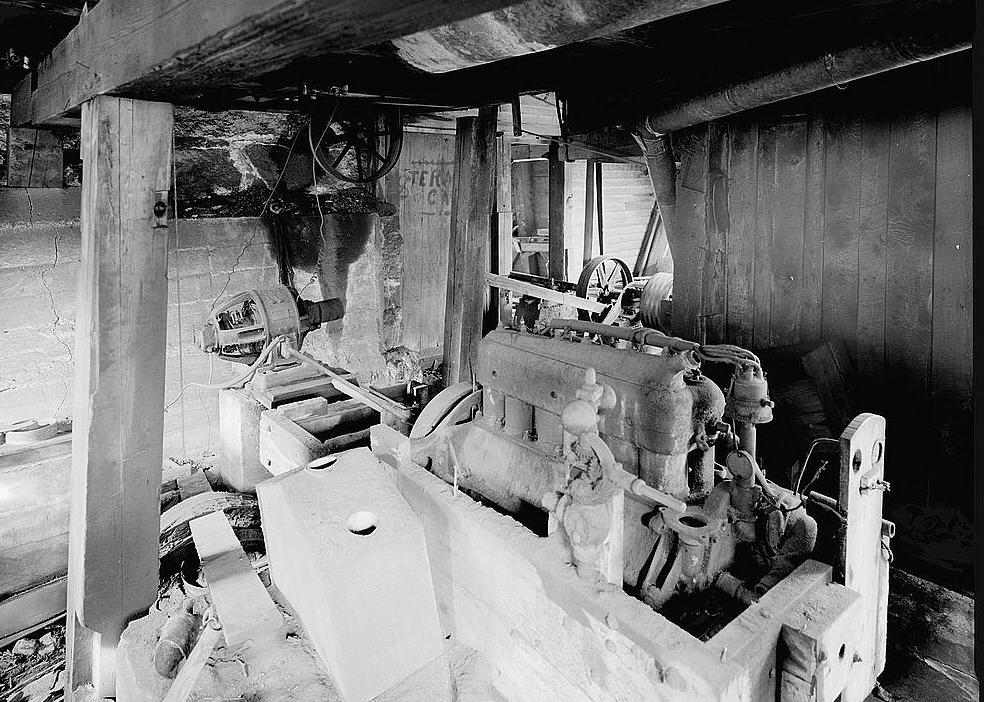 Ben Thresher's Mill, Barnet Vermont 1979 Generator Room (basement beneath Blacksmith Shop): view looking north showing remains of 1923 six-cylinder Studebaker engine and a dynamo