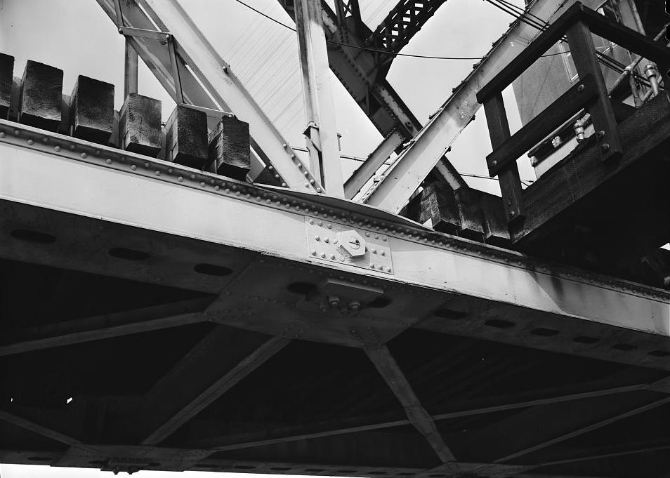 Bridgeport Swing Span Railroad Bridge, Bridgeport Alabama 1980 Close-up view showing portion of continuous bottom chord of truss with other web members and posts of the truss connected thereto at a joint by the use of a large steel pin. Note: The timber ties supporting the track (not shown but above) span transversely from truss to truss which are on 16' -0 centers.