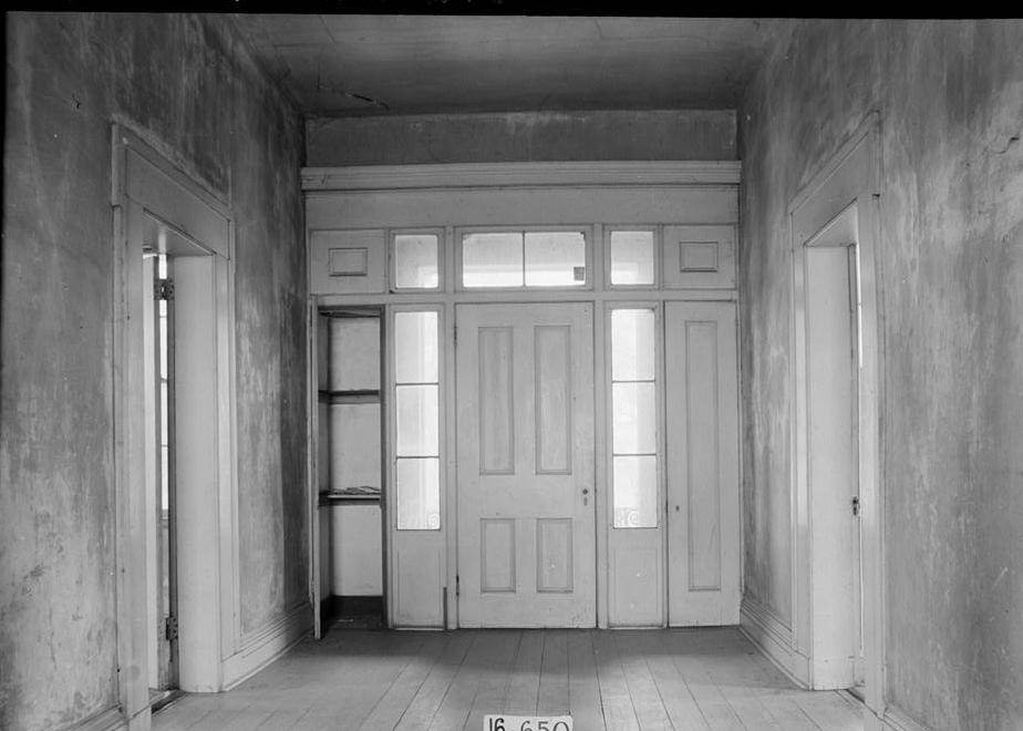 Stone-Young Plantation, Burkville Alabama 1935 FRONT HALL DOOR TO BALCONY SHOWING SMALL DOOR OPEN TO LEFT WITH SHELVES IN CLOSET, ALSO DOOR TREATMENT IN HALL