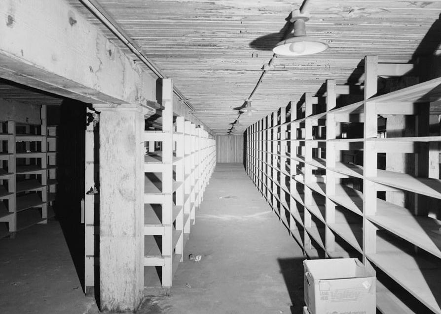 Southern Pacific Train Station Post Office, Sacramento California 1994 Interior view of loading dock basement facing east, showing wood posts and capitals, wood floor beams and flooring storage shelves