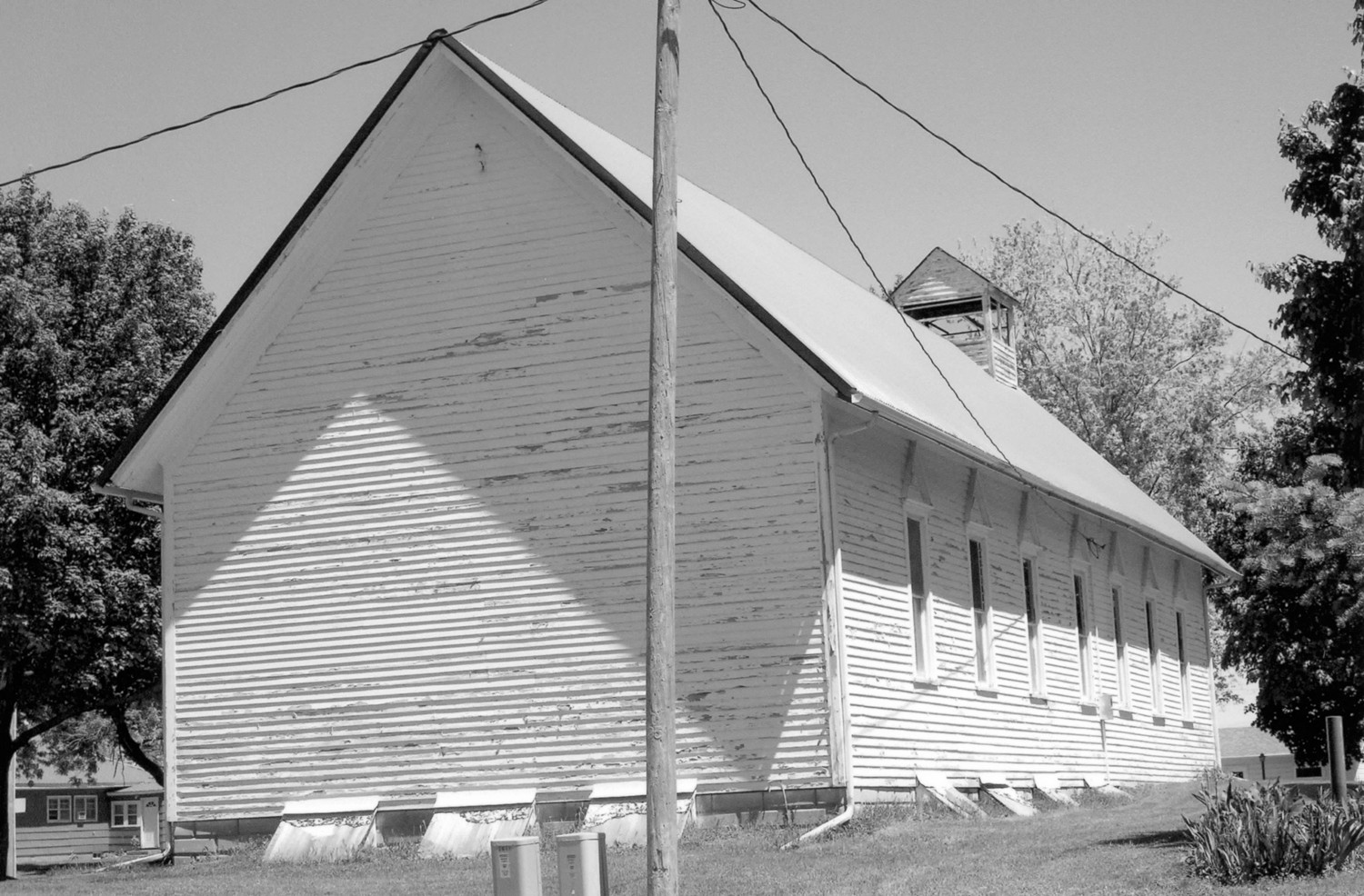First Presbyterian Church, West Bend Iowa Rear (west) and south elevations looking to the northeast. The 1889 church stretched from the front (east) of the church to the west, to include four of the windows seen on the south elevation of this view (2009)