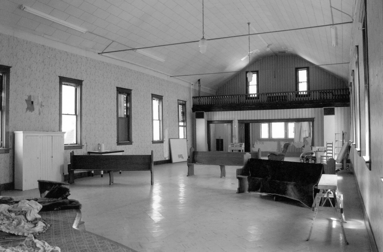 First Presbyterian Church, West Bend Iowa View of the sanctuary looking east toward the balcony. In this view looking to the north, the folding doors are open to the narthex. Note that the church ceiling and floors are covered in non-historic materials. The walls are papered as they were historically (1889) (2009)