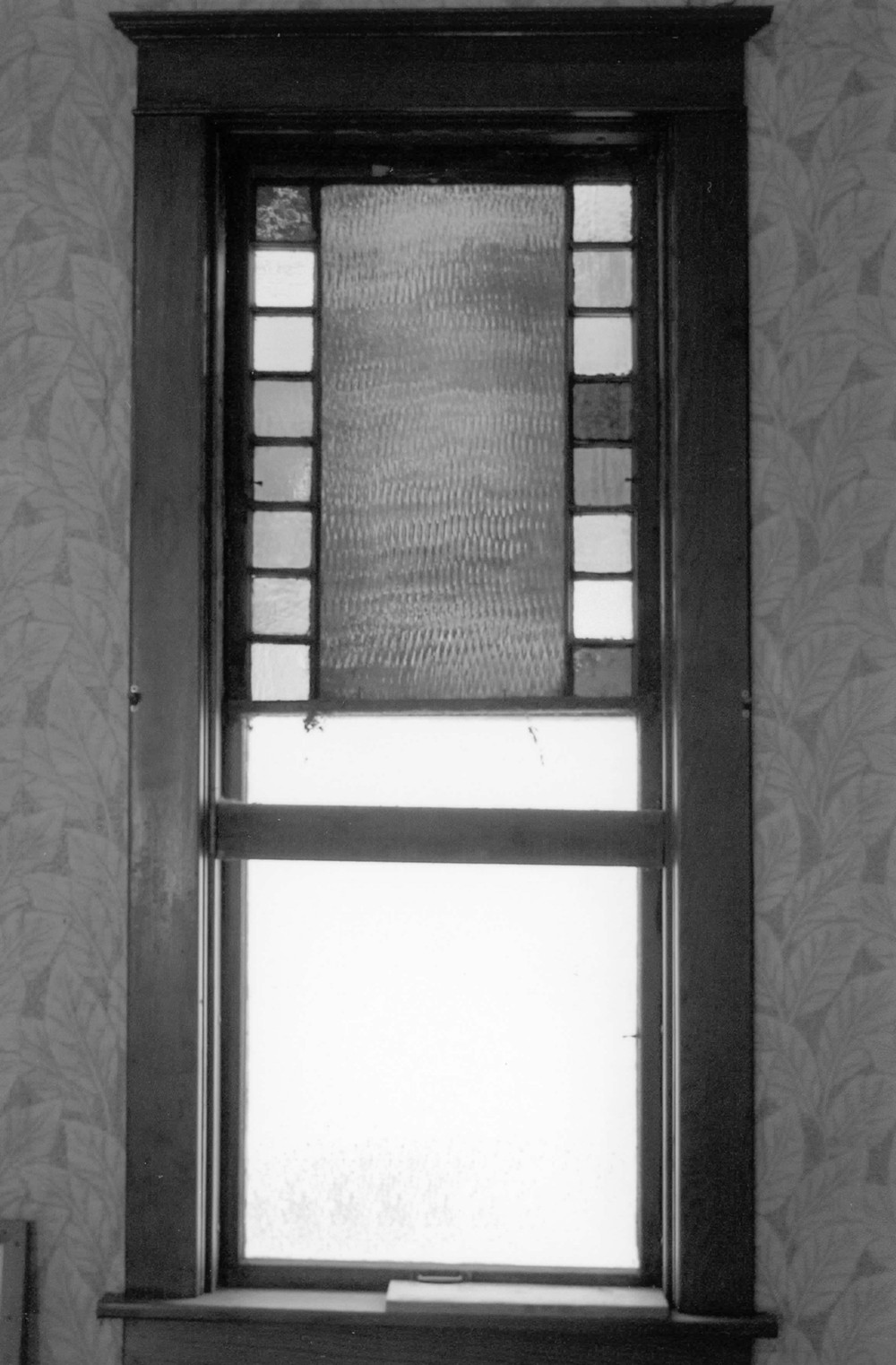 First Presbyterian Church, West Bend Iowa The glazing in the upper sash of this window dates to the original building; the use of small panes of colored glass is commonly referred to as a Queen Anne sash and was utilized during the Victorian era to which the original church dates. When the 1915 addition and interior renovation were completed, it is likely that the historic windows were moved to alternate with the new windows to create continuity between the 1889 building and the addition (2009)