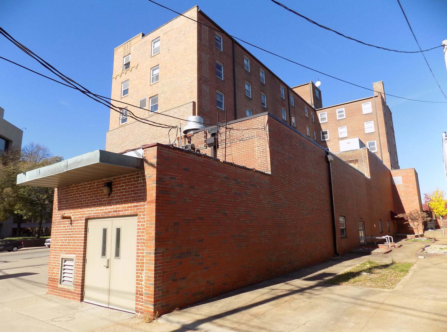 Hotel Belleville, Belleville Illinois East elevation (right) with historic and non-historic additions- addition in foreground with metal doors is non-historic, south elevation of hotel at left side (2017)