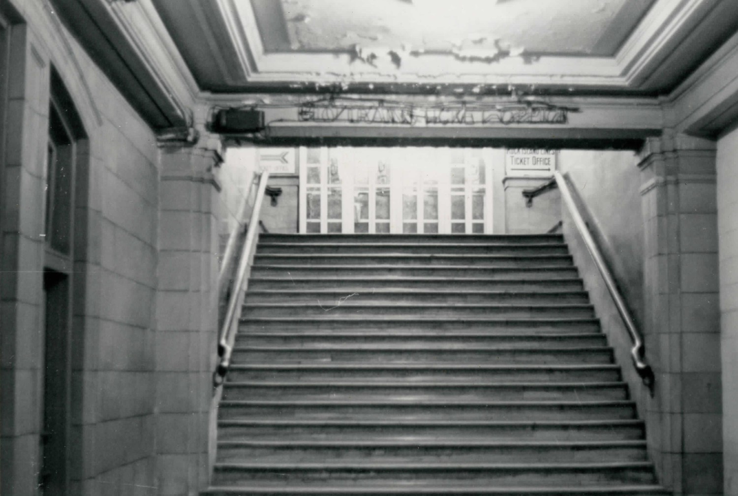 Union Railroad Station, Joliet Illinois Main street level entrance showing phone booths blocking stairs and access to old ticket counter (1977)
