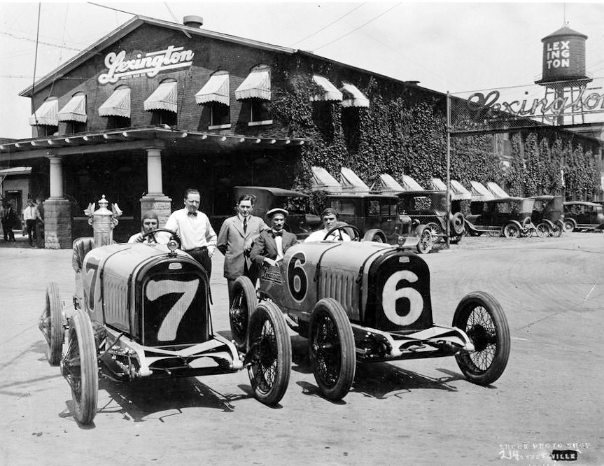 Lexington Motor - Auburn Automobile Company, Indiana 1920 VIEW OF TWO RACING CARS AND DRIVERS (ONE WITH A TROPHY) IN FRONT OF OFFICE BUILDING OF LEXINGTON MOTOR CO,