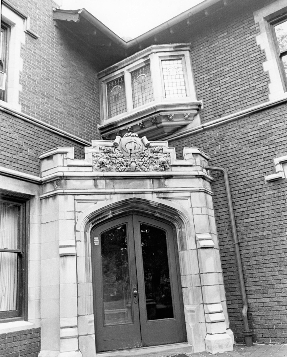 Alfred M. Glossbrenner Mansion, Indianapolis Indiana Main entry, showing stone-work, projecting window, and decorative rafter ends (1977)