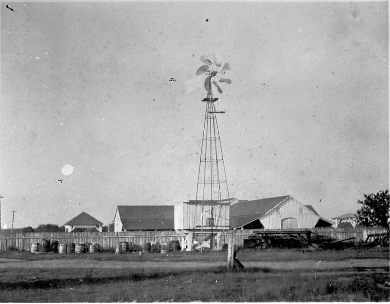 Mule barn looking north with windpump in foreground. 1906