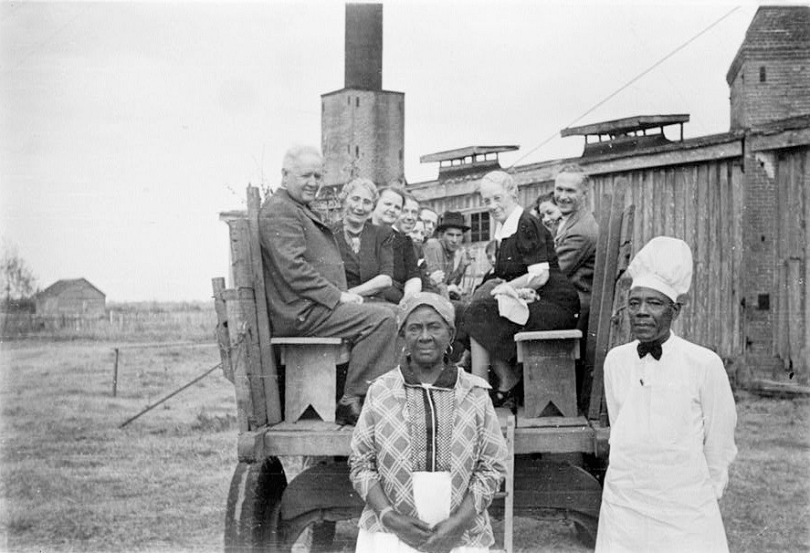 Laurel Valley Sugar Plantation, Thibodaux Louisiana Wilson J. Lepine family posed in a cane cart with plantation cooks standing in foreground. It was customary for the family to attend a Thanksgiving dinner held in the Boarding House; Wilson Lepine is the man sitting in the cart on the left. 1906
