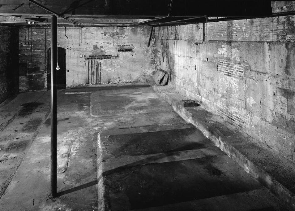 Boston Manufacturing Company, Waltham Massachusetts 1979 INTERIOR OF 1902 GENERATOR HOUSE. BASEMENT WALL OF 1901 STEAM ENGINE HOUSE VISIBLE AT REAR. BASEMENT WALL OF 1873 WING AT RIGHT. OPENINGS MADE FOR MECHANICALLY TRANSMITTING POWER FROM STEAM ENGINES TO GENERATORS HAVE BEEN BRICKED UP.