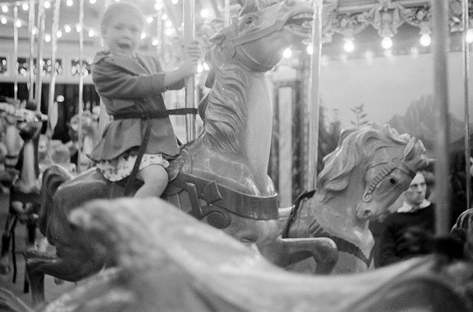 Glen Echo Amusement Park, Glen Echo Maryland A small girl enjoying a ride on the merry-go-round  (1939)