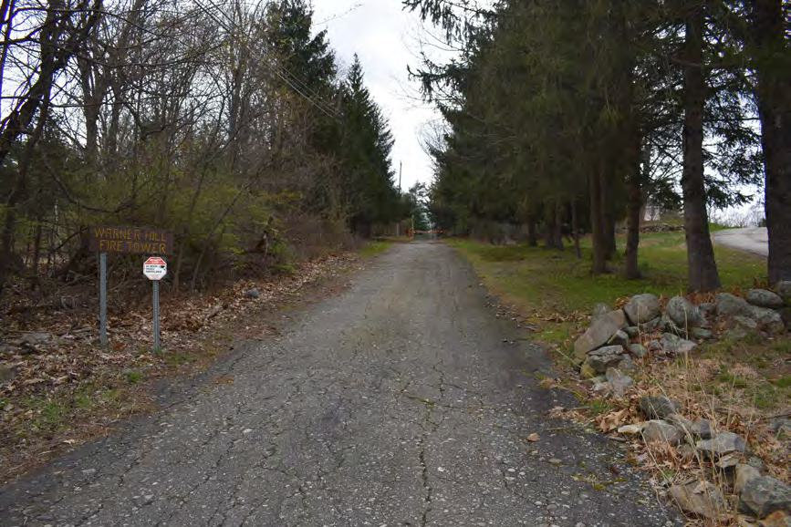 Warner Hill Fire Tower, Derry New Hampshire Asphalt-paved access road (Wardens Way) from Warner Hill Road to fire tower (2022)