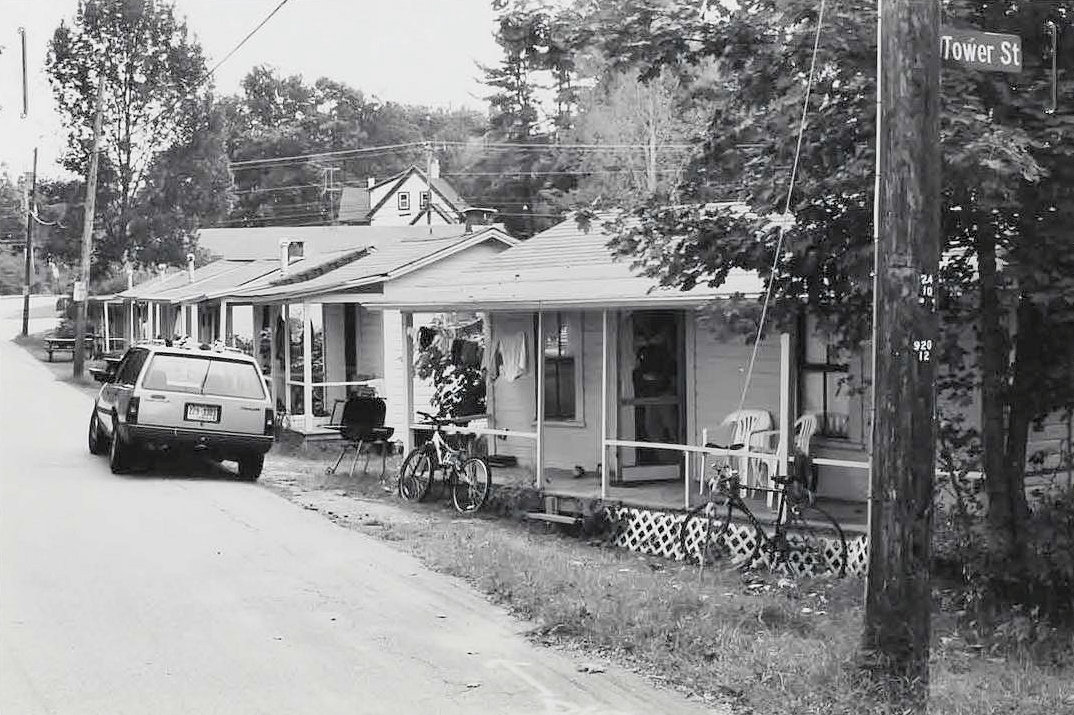 Weirs Highlands Camp and Cottages, Laconia New Hampshire Cabins (F-L) along Warner Avenue with roof of Motel Building visible beyond (2006)