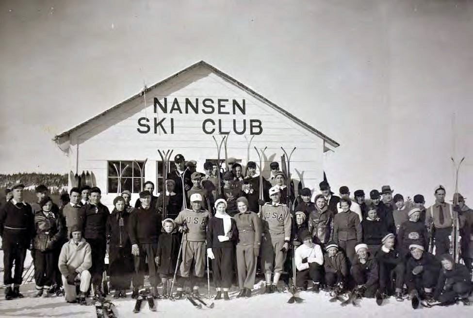 Nansen Ski Jump, Milan New Hampshire Nansen Ski Club members in front of their clubhouse (not extant) ca. 1940. Club members Bob Reid (front left) and Erling Anderson (front right) are pictured wearing their U.S. Olympic uniforms (1940)