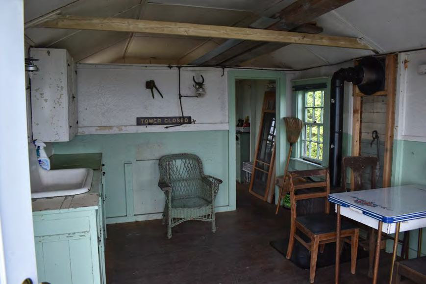 Croydon Peak Fire Tower, Newport New Hampshire Watchman's Cabin interior southeast room, showing kitchen, partitions, and replacement stove (2022)