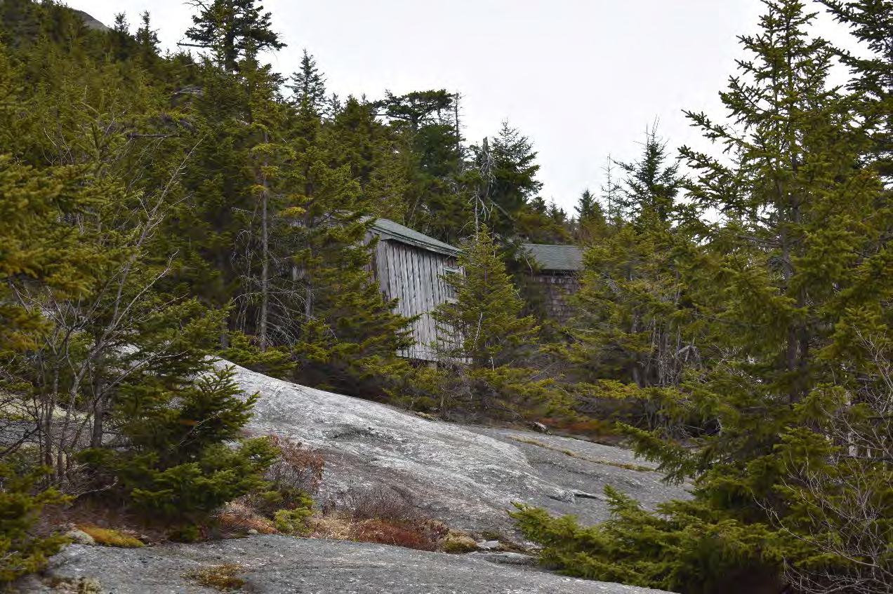 Mount Cardigan Fire Tower, Orange New Hampshire Storage Building and Watchman's Cabin (behind), looking northeast (2022)