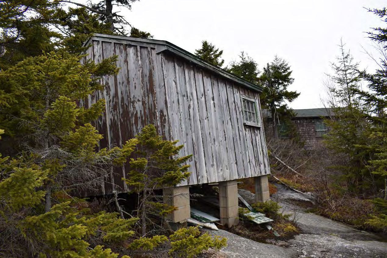 Mount Cardigan Fire Tower, Orange New Hampshire Storage Building and Watchman's Cabin (behind), looking northeast (2022)