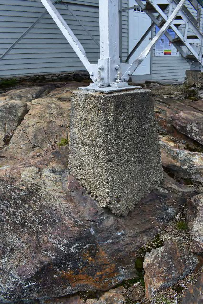 Pack Monadnock Fire Tower, Peterborough New Hampshire Concrete footing of Fire Tower with Ambient Air Monitoring Station behind (2022)