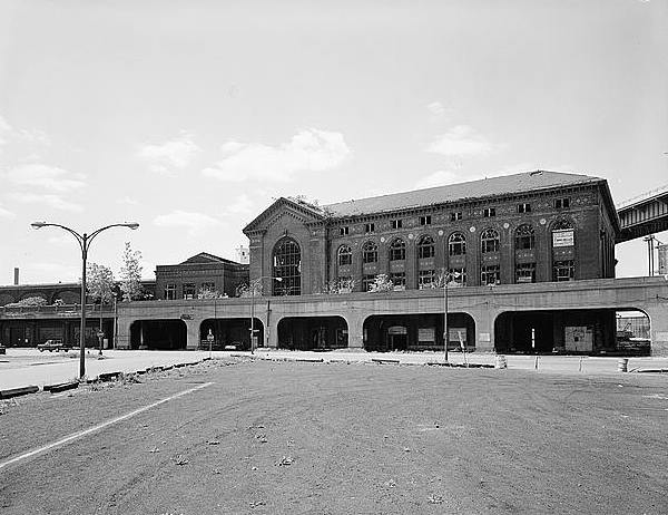 Delaware, Lackawanna, and Western RR. Lackawanna Terminal (Buffalo Boat Depot), Buffalo New York Facade of two brick passenger terminal buildings of DL&W from parking lot at the foot of Main Street across South Park Avenue. Arched portion was elevated rail spur which originally continued westward a few hundred yards. 