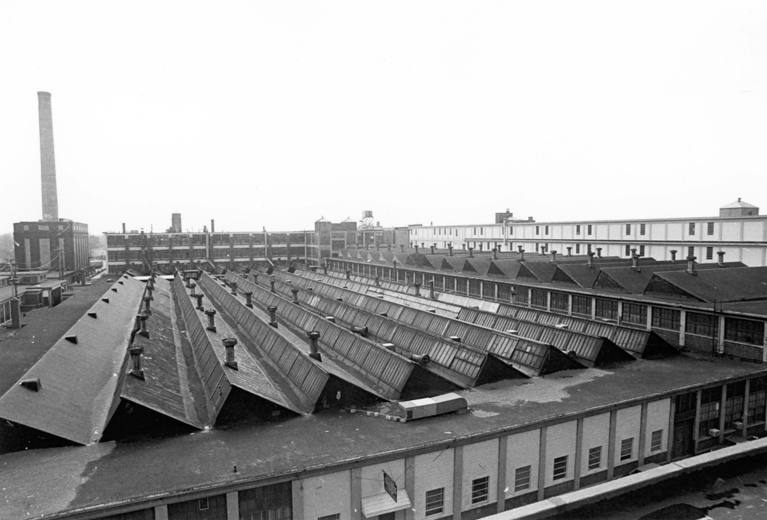 Pierce Arrow Factory Complex, Buffalo New York View of sawtooth roofs of Manufacturing Building (foreground) and the Assembly Building (to the right) as seen looking east over complex from the Administration Building (1974)
