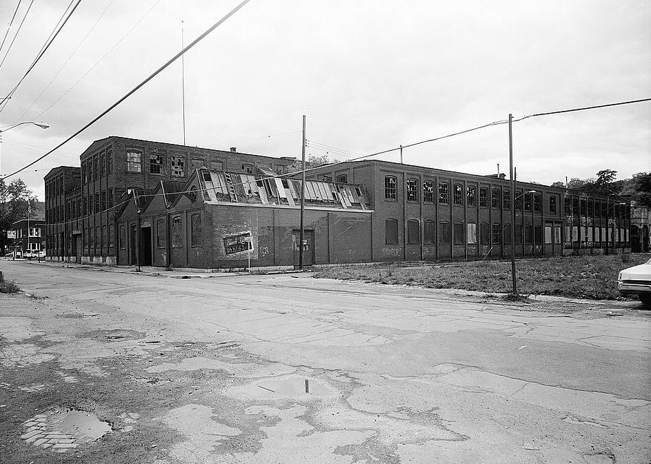 Merrill Silk Mill, Hornell New York 1979 View from northeast corner, Canisteo and Spruce Streets. Photo shows the garage area (Building #5) with sawtooth roofline and front elevation of Buildings #6 and #1.