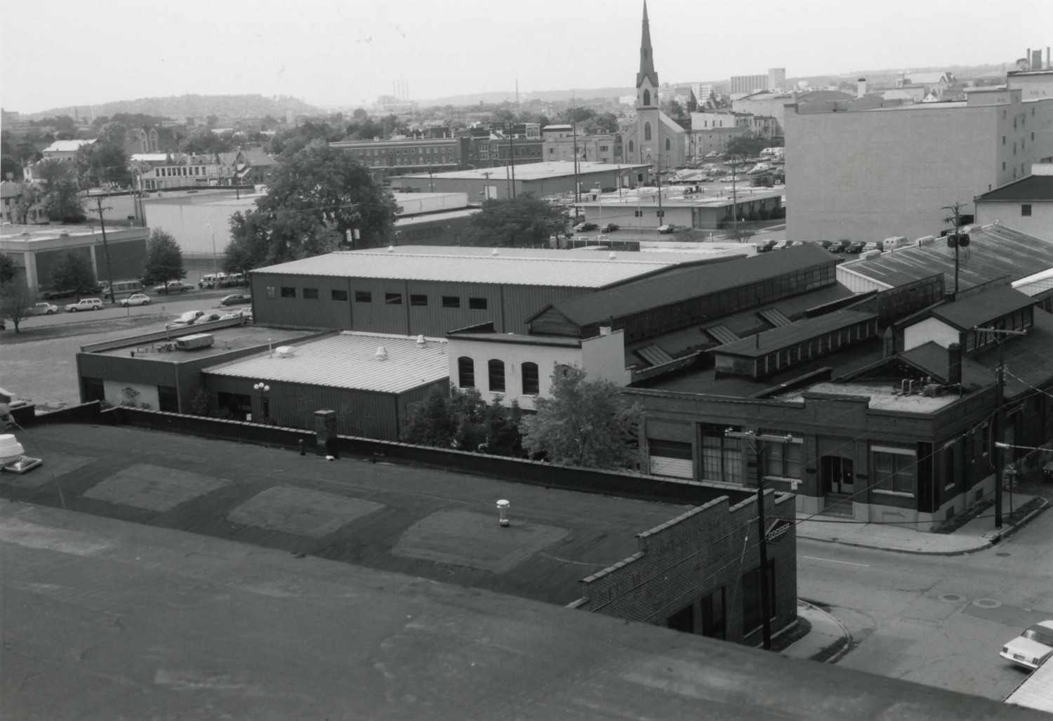 Dayton Motor Car Company, Dayton Ohio Looking southwest toward Oregon District, which is behind the church with spire. Buildings #7a, #4, #3, #2a & b between photographer and church (1983)