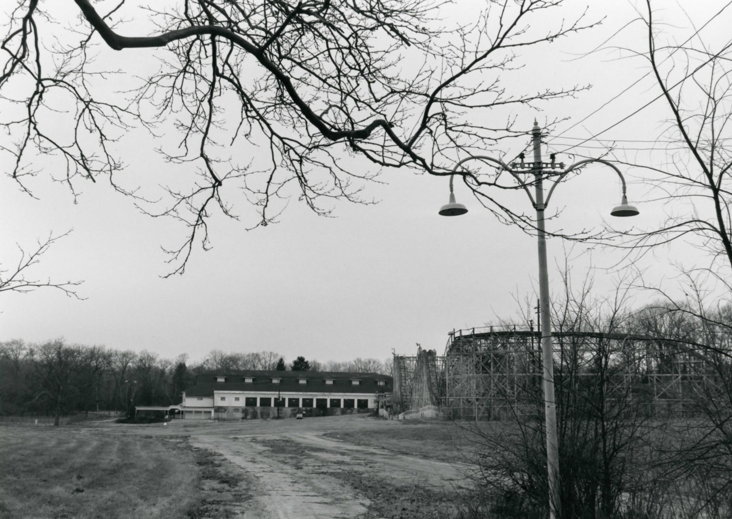 Idora Park, Youngstown Ohio Distant view of the park from the main southeast entrance, showing an historic lamp post in the foreground, the Jack Rabbit roller coaster at right and the ballroom at left. At far left is the entrance gate. (1992)