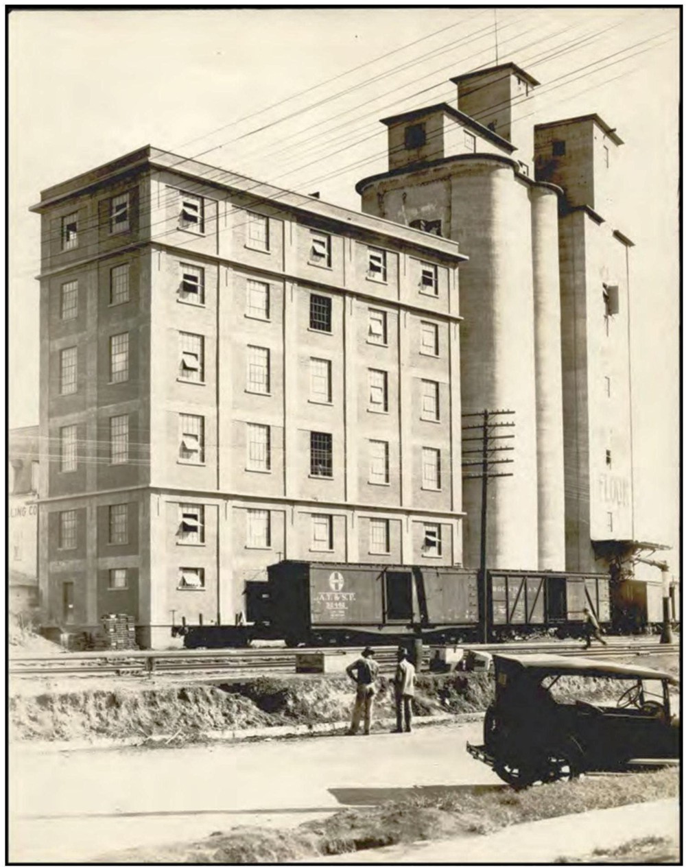 Ponca City Milling Company Elevator, Ponca City Oklahoma The west elevation of the six-story brick-clad structure which predates the towering granaries to its south. The train tracks ran adjacent to the mill, making transferring the milled products easy to transport. (1927)