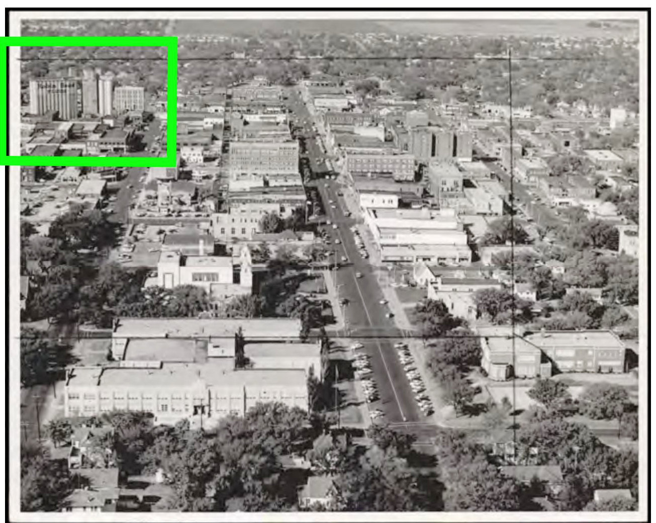 Ponca City Milling Company Elevator, Ponca City Oklahoma 1949 Ponca City was a bustling downtown, with the Ponca City Milling Company Elevator towers in the background. Identified in the green box in the upper left-hand corner of the top and enlarged in the bottom image, the mill details of the past that remain associated with the elevator today are identifiable. The is now a ghost sign. (1949)