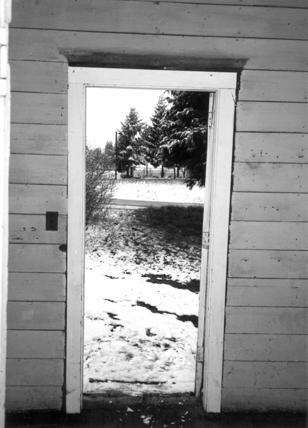 Victor Point School, Silverton Oregon View through anteroom door to outside. Light switch on wall on left. Not original door molding (1996)