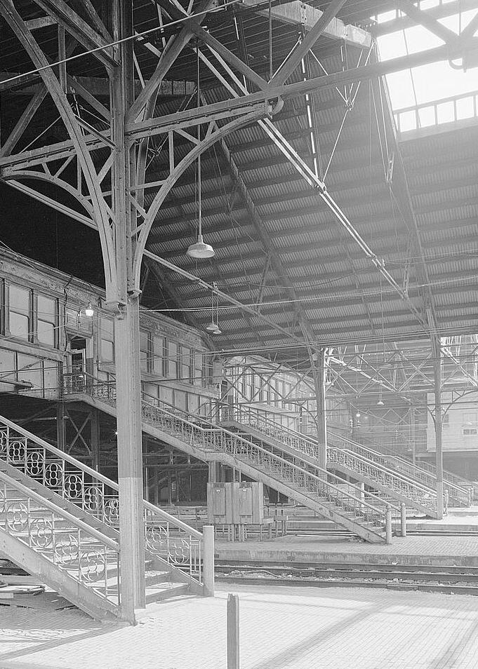 Harrisburg Train Station & Trainshed, Harrisburg Pennsylvania 1981  CONCOURSE (NORTH SIDE), PLAZA LEVEL, LOOKING TOWARD STATION BUILDING, SHOWING PASSENGER ACCESS STAIRS. NOTE TYPICAL SHED COLUMN BRACKETS.