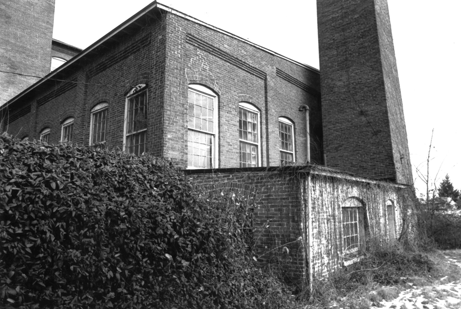 Ashley and Bailey Silk Mill, Marietta Pennsylvania Looking from the southwest corner of the site looking in a northeasterly direction at the corner of the boiler house with its smokestack (1980)