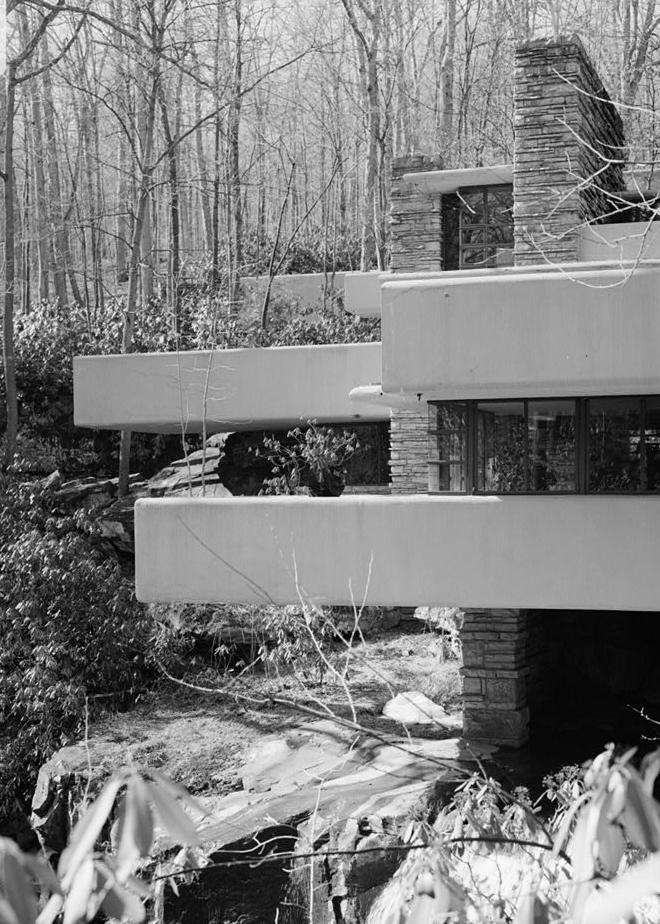 FallingWater - Frank Lloyd Wright House, Mill Run Pennsylvania VIEW FROM SOUTHEAST OF WEST TERRACES CONTRASTING HORIZONTAL CONCRETE CANTILEVERS WITH VERTICAL MASONRY SUPPORTS.
