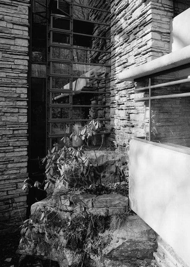FallingWater - Frank Lloyd Wright House, Mill Run Pennsylvania NATURAL BOULDER, THREE-STORY WINDOW AND STONE CHIMNEY FROM WEST TERRACE.