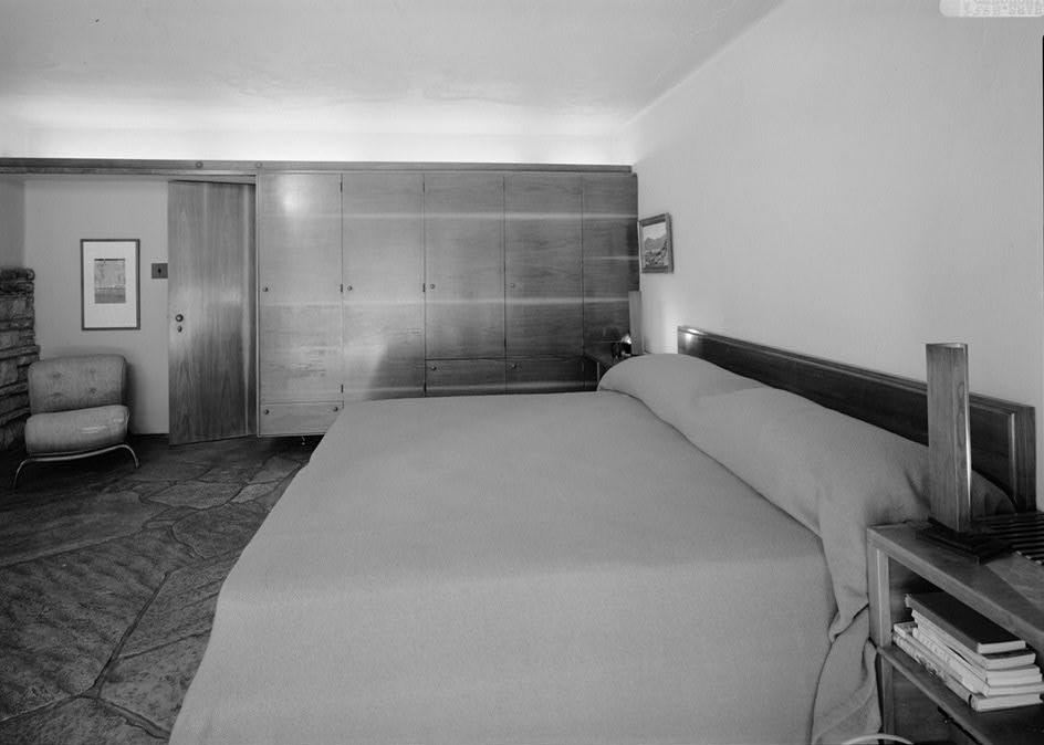 FallingWater - Frank Lloyd Wright House, Mill Run Pennsylvania NORTH WALL OF MASTER BEDROOM. NOTE BUILT-IN WALNUT BED AND CABINETRY WITH MATCHED HORIZONTAL SAP STREAKS.