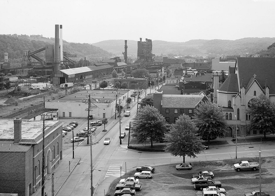 Pittsburgh Steel Company Monessen Works, Monessen Pennsylvania 1995 VIEW FACING EAST ON DONNER AVENUE WITH CONVEYOR LEADING TO COKE PLANT TO THE LEFT. REMAINS OF BASIC OXYGEN FURNACE IN CENTER BACKGROUND AND CHURCH ON SCHOONMAKER STREET TO THE RIGHT.