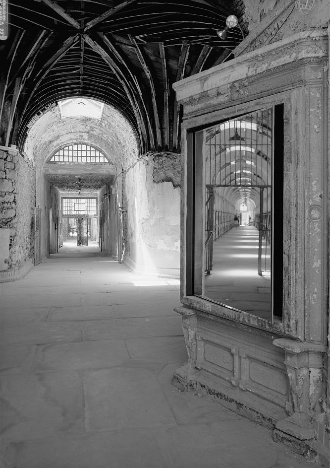 Eastern State Penitentiary, Philadelphia Pennsylvania Interior view, south corridor at cell blocks eight and nine, facing south (note cell block nine reflected in mirror) (1998)