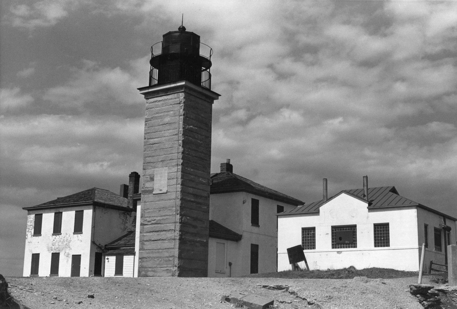 Beavertail Lighthouse, Jamestown Rhode Island Facing northwest, showing left to right, assistant keepers house, light tower, keepers house, and old signal house (1976)