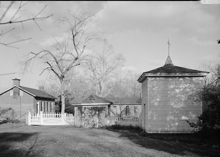 Colonel McNeal House, Bolivar Tennessee 1974 VARIOUS OUTBUILDINGS: a) OCTAGONAL STRUCTURE (center): WASH HOUSE b) SQUARE BUILDING WITH HIPPED ROOF (right front): SMOKEHOUSE c) BRICK BUILDING WITH END CHIMNEYS (left front): KITCHEN AND COOK'S BUILDING d) LONG BRICK BUILDING (in background): SERVANTS' QUARTERS (?)