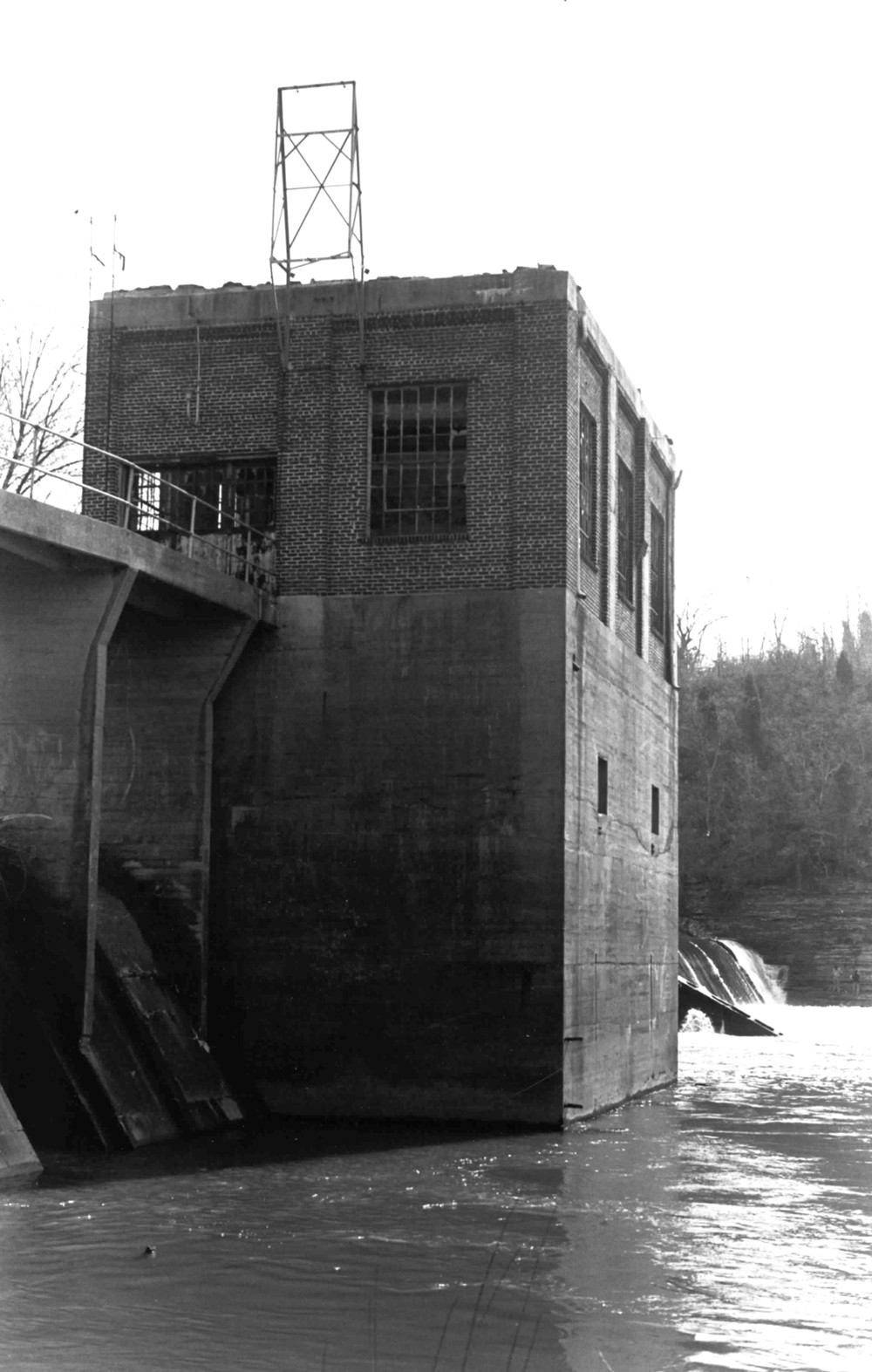 Columbia Hydroelectric Station, Columbia Tennessee View of Columbia powerhouse showing concrete foundation, brick superstructure, walkway, fishladder and dam spillway. Looking west (1989)