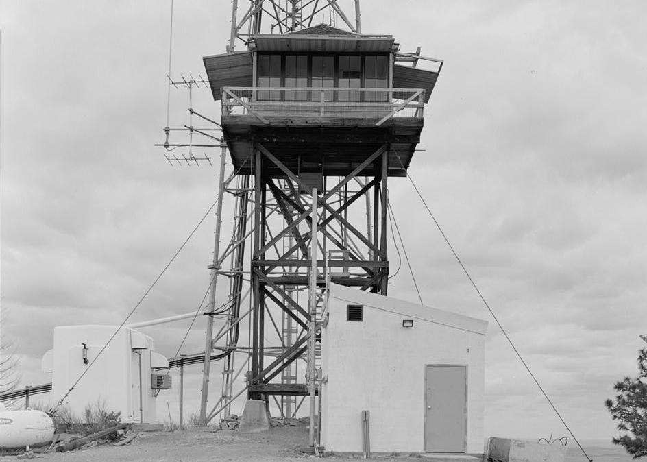 Chelan Butte Lookout - Fire Watchtower, Chelan Washington 1995  West side elevation view includes small buildings for communications equipment and cellular communications tower in background.