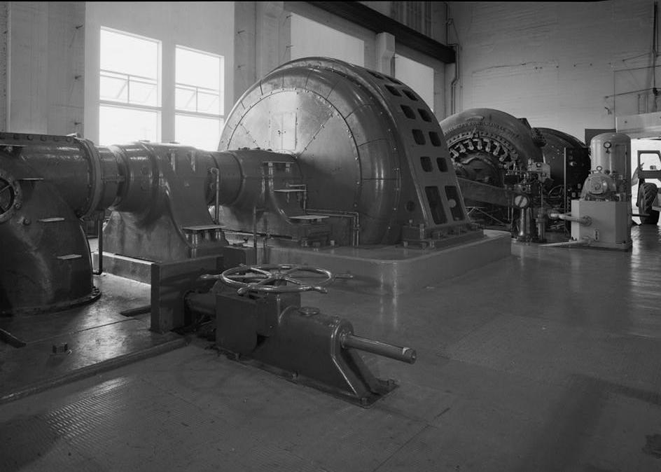 Puget Sound Power & Light Company, White River Hydroelectric Project, Dieringer Washington Butterfly valve for turbine unit no. 2. Beyond is a General Electric AC generator directly connected to turbine unit no. 2 (1989)