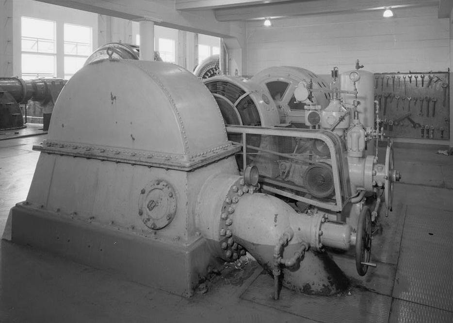 Puget Sound Power & Light Company, White River Hydroelectric Project, Dieringer Washington View in Generator Room of exciter unit no. 1; looking northwest. This unit includes a Pelton wheel manufactured by Allis Chalmers, no. 261, type C-1, Breaking Horse Power 600, head 370 feet, and 360 rpm; a General Electric DC generator, no. 1357609, type MPC 8, 340-350 form LD, 1360 amp, 350 rpm, 250 volts (no load), 250 volts (full load); and a General Electric induction motor, no. 4228863, type KT-4424, 20-500-360 form A, 60 cycles, 45 amp, 6,600 volts, 500 horsepower, continuous 50-degree centigrade rise, 350 rpm with full-load (1989)