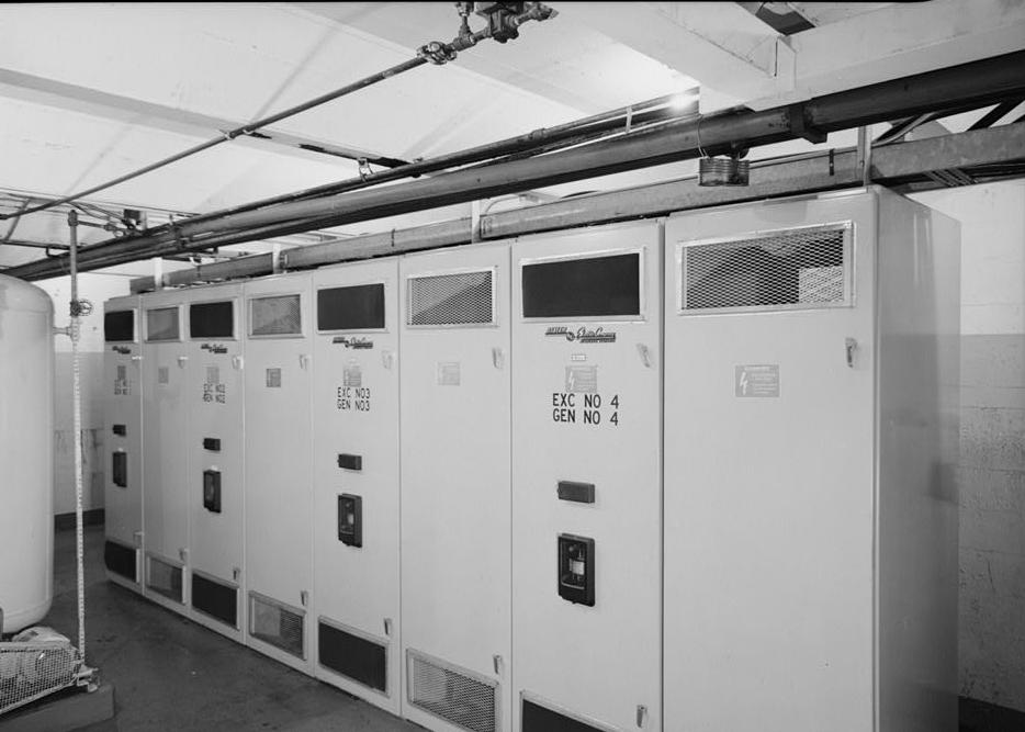 Puget Sound Power & Light Company, White River Hydroelectric Project, Dieringer Washington Room B-2 (below floor of generator room) showing solid state exciters; there are four exciter units--one per generator--each manufactured by Basler Electric Company of Highland, Illinois, and dating from the 1960s. The oil tank to the left was installed about 1979 (1989)