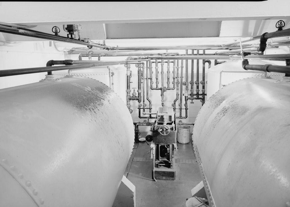 Puget Sound Power & Light Company, White River Hydroelectric Project, Dieringer Washington Oil filter room in basement (Room B-1) where oil used in lubrication in generator room is cleaned and recycled. The two tanks in the foreground each have capacities of 2,100 gallons (1989)